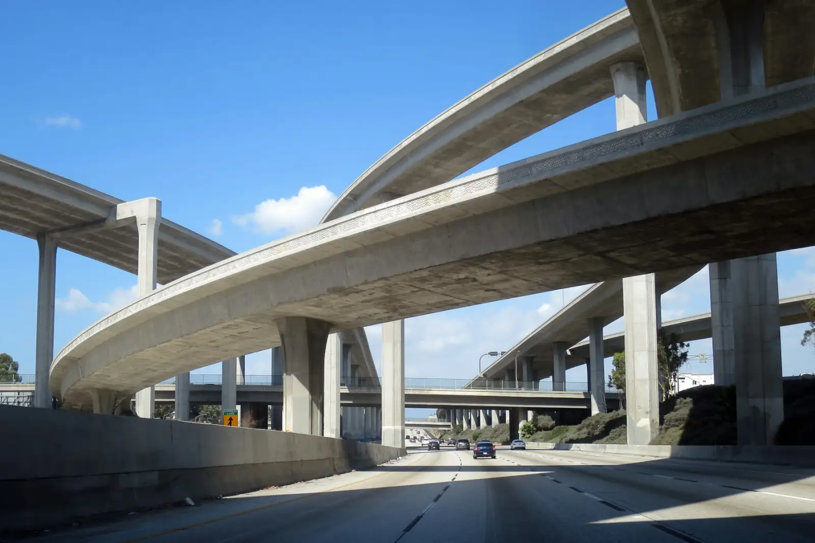 Traffic passing under curved overpasses at a large freeway interchange