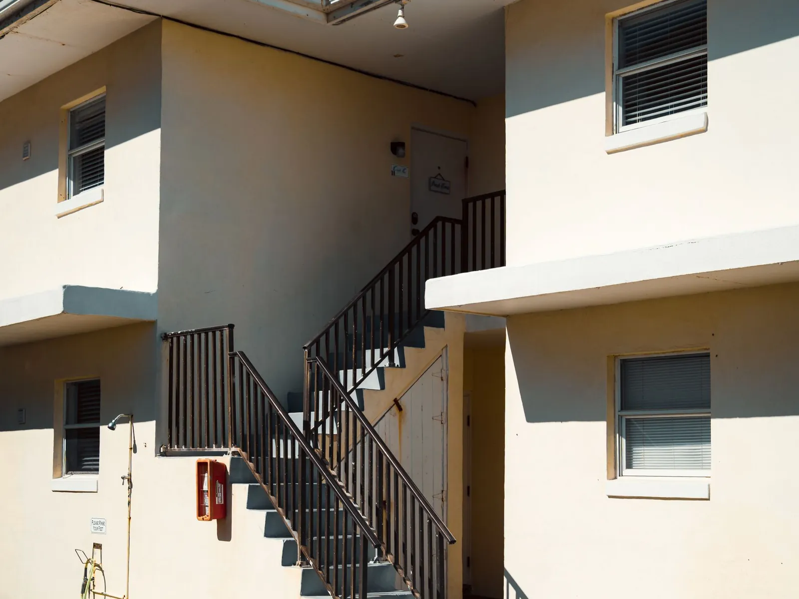 Exterior stairs and walkway at a two-story apartment building