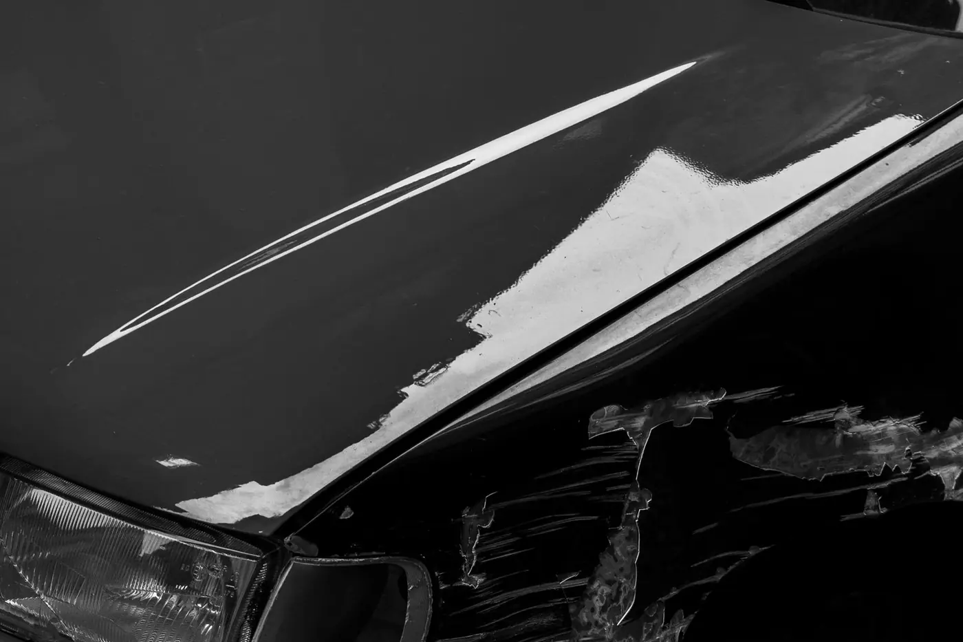 Scratches along the front fender of a parked car